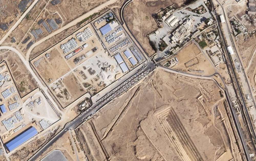 This satellite photo from Planet Labs PBC shows trucks lined up on the Egyptian side of the Rafah border crossing with the Gaza Strip on Thursday, Oct. 16, 2025. (Planet Labs PBC via AP)