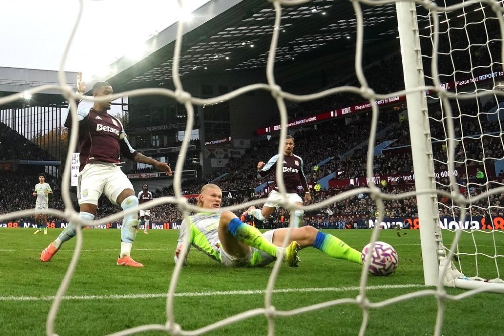 Manchester City's Erling Haaland scores a goal before being ruled out for offside via VAR during the English Premier League match between Aston Villa and Manchester City, in Birmingham, England, Sunday Oct. 26, 2025. (Nick Potts/PA via AP)