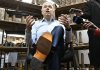 Federal Finance Minister Francois Philippe Champagne shows his new shoes he will wear for the budget speech while participating at the making of the shoes, at the Boulet boot factory in St-Tite Que., on Monday, Nov. 3, 2025.  THE CANADIAN PRESS/Jacques Boissinot