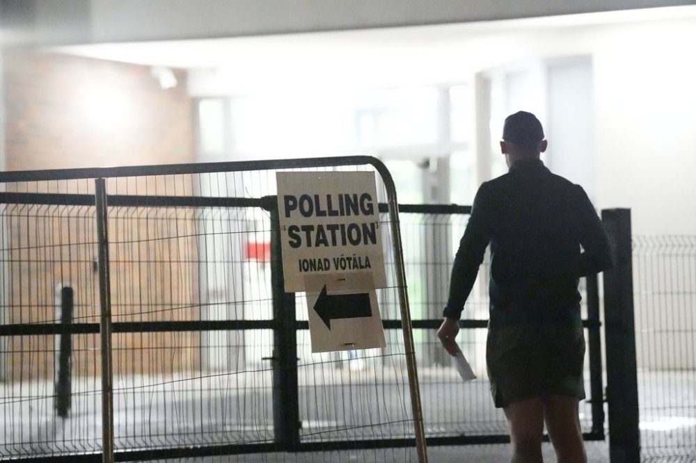 Early voters arrive at Scoil Mhichil Naofa (St Michael's National School) in Athy, Co Kildare, as voting beings in Ireland's presidential election, Friday, Oct. 24, 2025. (Niall Carson/PA via AP)