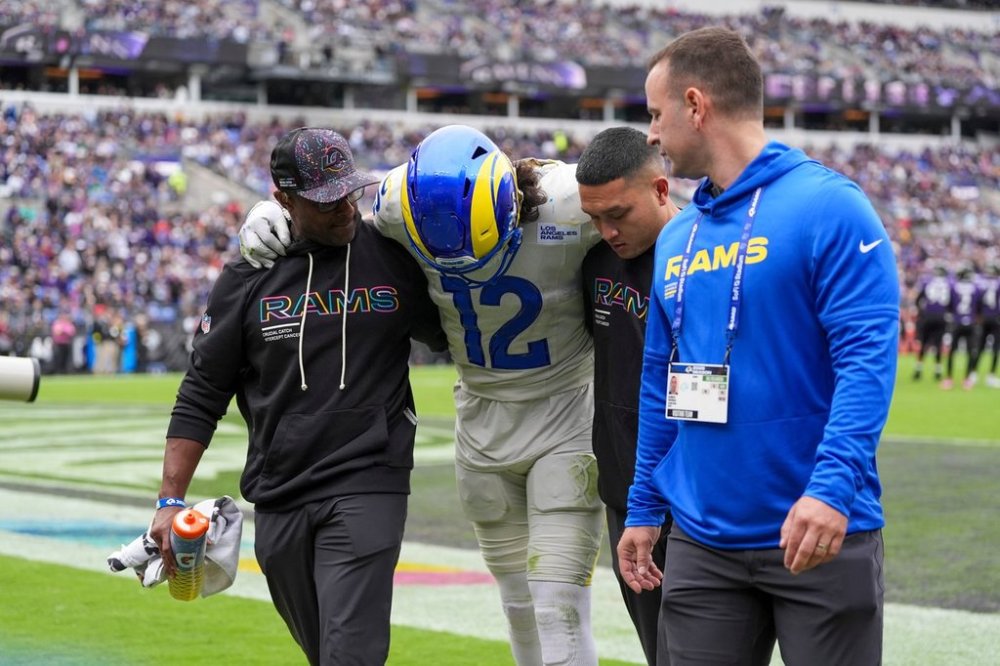Trainers help Los Angeles Rams wide receiver Puka Nacua off the field during the first half of an NFL football game against the Baltimore Ravens Sunday, Oct. 12, 2025, in Baltimore. (AP Photo/Stephanie Scarbrough)