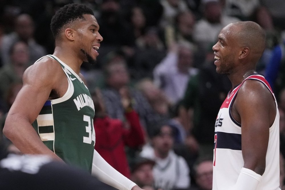 Milwaukee Bucks' Giannis Antetokounmpo and Washington Wizards' Khris Middleton share a laugh during the second half of an NBA basketball game Wednesday, Oct. 22, 2025, in Milwaukee. (AP Photo/Morry Gash)