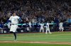 Toronto Blue Jays' George Springer reacts after hitting a three run home run against the Seattle Mariners during the seventh inning in Game 7 of baseball's American League Championship Series, Monday, Oct. 20, 2025, in Toronto. (AP Photo/David J. Phillip)