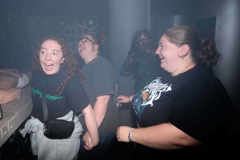 Visitors react while attending the Erebus Haunted House, Oct. 4, 2025, in Pontiac, Mich. (AP Photo/Ryan Sun)