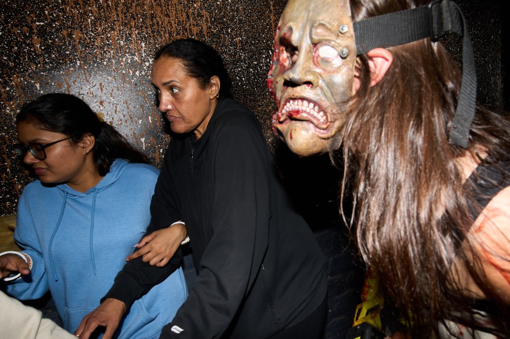 Visitors react while attending the Erebus Haunted House Saturday, Oct. 4, 2025, in Pontiac, Mich. (AP Photo/Ryan Sun)