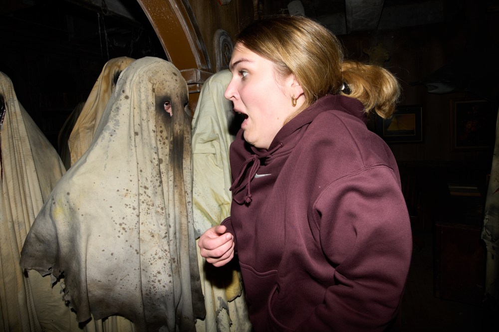 Visitors react while attending the Erebus Haunted House, Oct. 4, 2025, in Pontiac, Mich. (AP Photo/Ryan Sun)