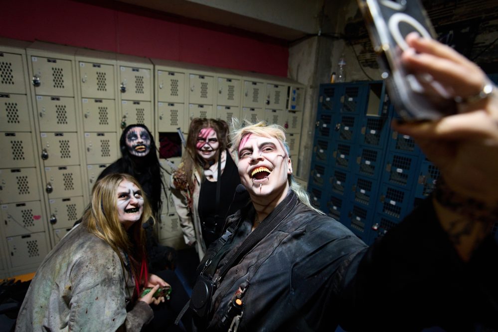 Actors take a selfie at the Erebus Haunted House, Oct. 2, 2025, in Pontiac, Mich. (AP Photo/Ryan Sun)