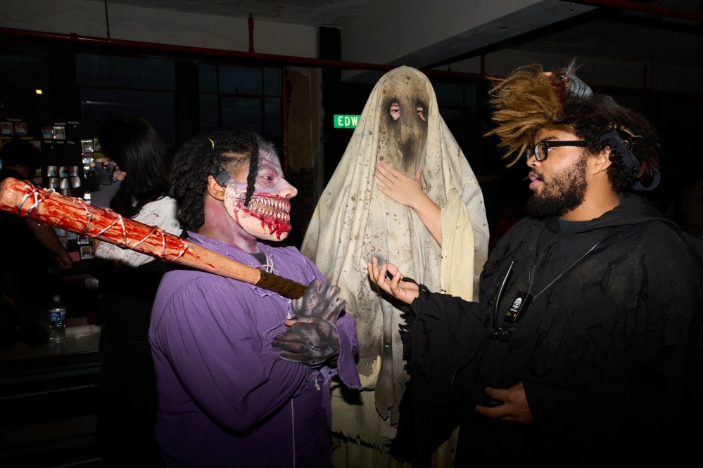 Alan Tucker, left, speaks with actors at the Erebus Haunted House Thursday, Oct. 2, 2025, in Pontiac, Mich. (AP Photo/Ryan Sun)