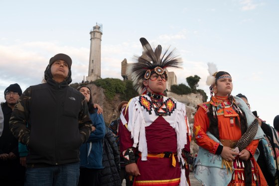 People watch the sun rise during a gathering on Indigenous Peoples Day on Alcatraz Island on Monday, Oct. 13, 2025, in San Francisco. (Laure Andrillon / The Associated Press files)