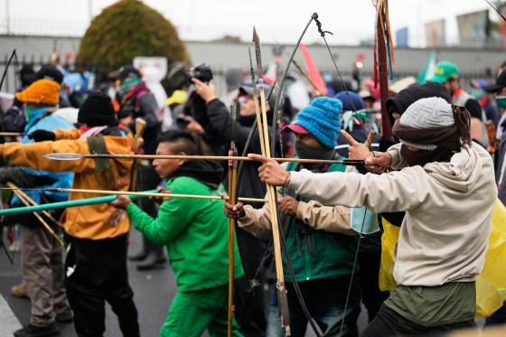 Indigenous people shoot arrows at police officers near the entrance of U.S embassy during a protest demanding action from President Gustavo Petro's government on social, environmental and security issues in Bogota, Colombia on Oct. 17, 2025. (Fernando Vergara / The Associated Press files)