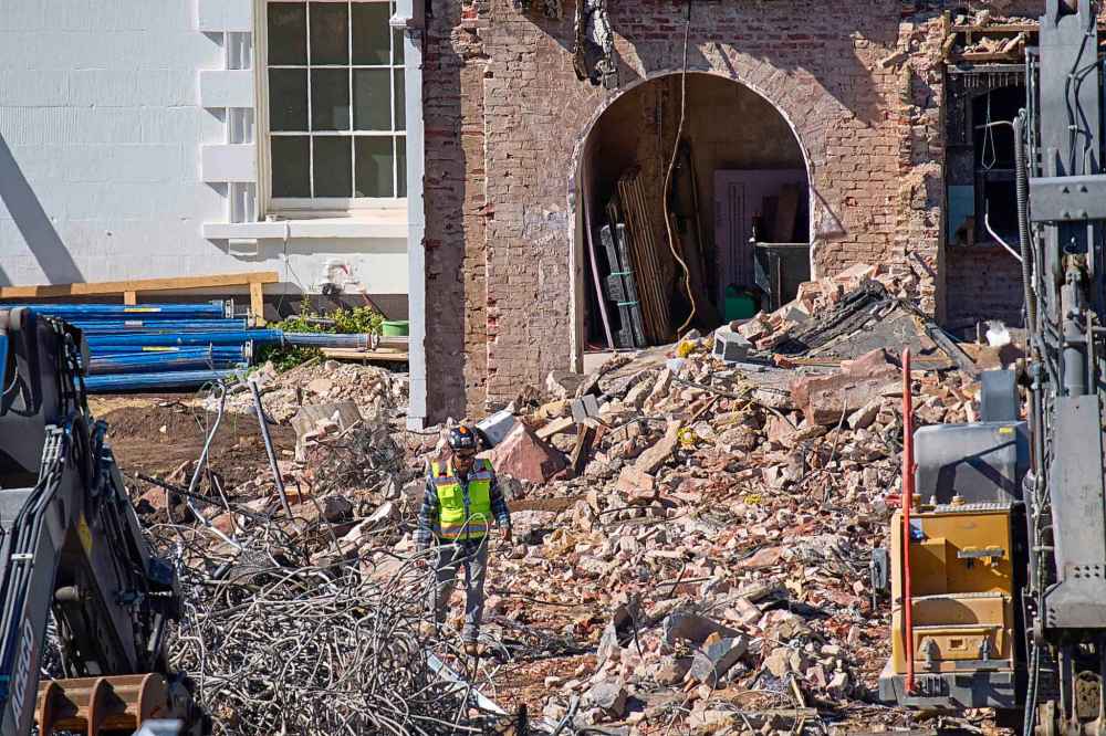 A worker walks through debris at a largely demolished part of the East Wing of the White House, Thursday, Oct. 23, 2025, in Washington, before construction of a new ballroom. (AP Photo/Jacquelyn Martin)