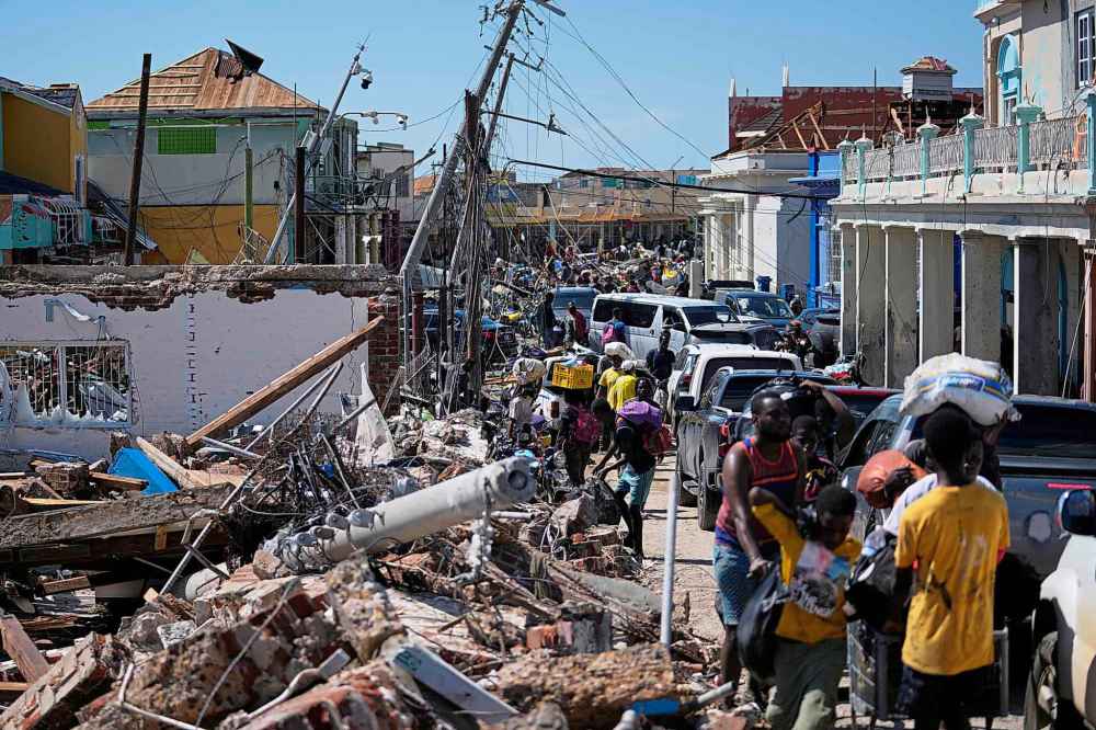 Residents jam a street in Black River, Jamaica, Thursday, Oct. 30, 2025, in the aftermath of Hurricane Melissa. (AP Photo/Matias Delacroix)