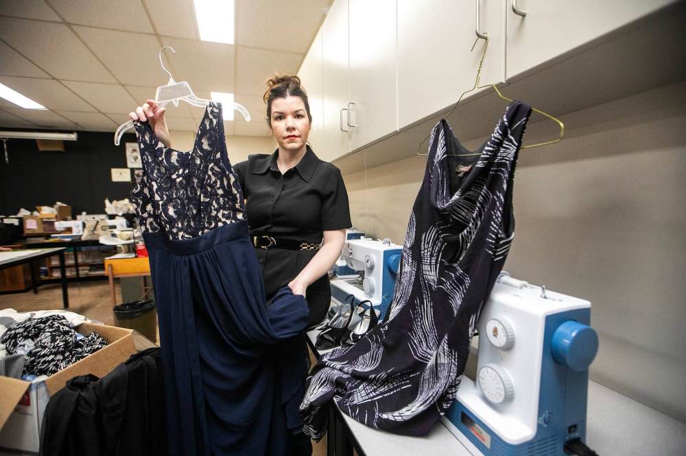 MIKAELA MACKENZIE / FREE PRESS
Jenna Malmo, a sewing teacher at St. John's High School, with donated formal wear for Gowns for Grads on Thursday. The Winnipeg volunteer-run organization was evicted from its Exchange District headquarters this summer.
