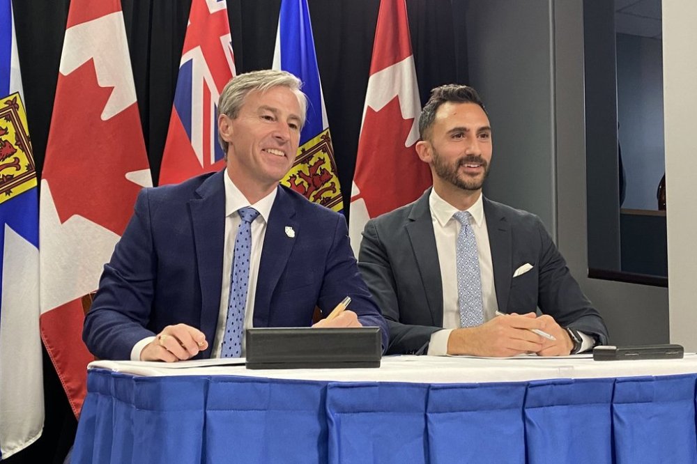 Nova Scotia Premier Tim Houston, left, and Ontario Energy Minister Stephen Lecce sign a memorandum of understanding to work together in exploring the use of small modular reactor technology, in Halifax, on Thursday, Oct. 23, 2025. THE CANADIAN PRESS/Keith Doucette