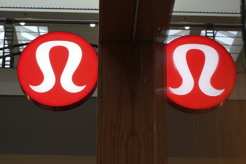 The Lululemon logo is reflect in a window of a Lululemon store in the Walden Galleria in Buffalo, NY, on Saturday, Nov. 30, 2024. (AP Photo/Gene J. Puskar)