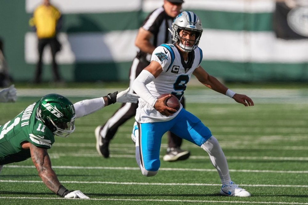 Carolina Panthers quarterback Bryce Young (9) avoids a tackle from New York Jets linebacker Jermaine Johnson II (11) during the second quarter of an NFL football game, Sunday, Oct. 19, 2025, in East Rutherford, N.J. (AP Photo/Seth Wenig)