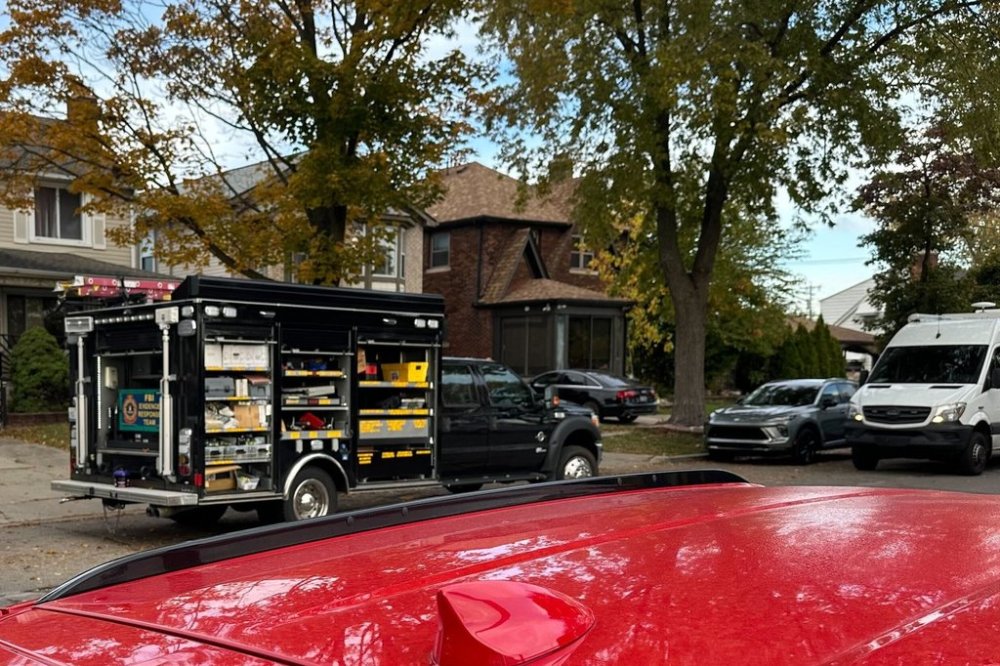 An FBI Evidence Response Team truck is seen idling in a Dearborn, Mich., neighborhood on Friday, Oct. 31, 2025. (AP Photo/Mike Householder)