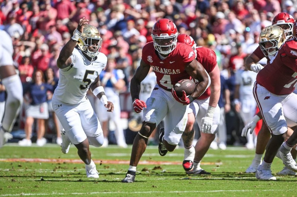 Arkansas running back Mike Washington Jr. (4) runs past Notre Dame defensive lineman Boubacar Traore (5) during the first half of an NCAA college football game Saturday, Sept. 27, 2025, in Fayetteville, Ark. (AP Photo/Michael Woods)