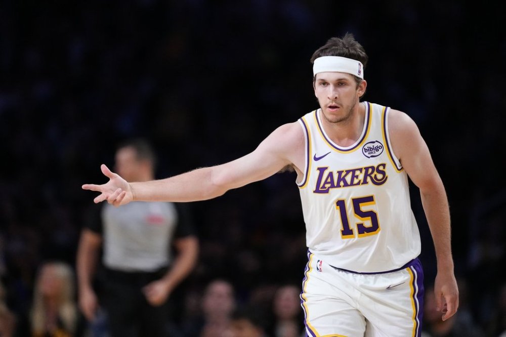 Los Angeles Lakers' Austin Reaves (15) celebrates his three-point basket during the first half of a preseason NBA basketball game against the Golden State Warriors Sunday, Oct. 12, 2025, in Los Angeles. (AP Photo/Jae C. Hong)