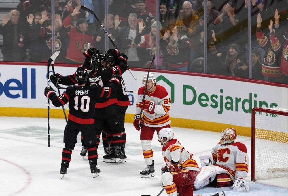 Calgary Flames goaltender Devin Cooley (1) looks on after being scored on by Ottawa Senators' Jake Sanderson (85) to tie the game during third period NHL hockey action in Ottawa, on Thursday, Oct. 30, 2025. THE CANADIAN PRESS/Justin Tang