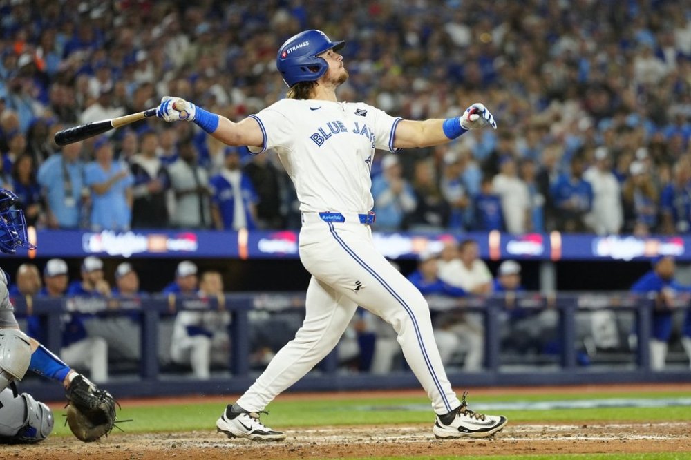 Toronto Blue Jays' Addison Barger (47) watches the ball after hitting a grand slam against the Los Angeles Dodgers during sixth inning Game 1 World Series playoff MLB baseball action in Toronto on Friday, Oct. 24, 2025. THE CANADIAN PRESS/Frank Gunn