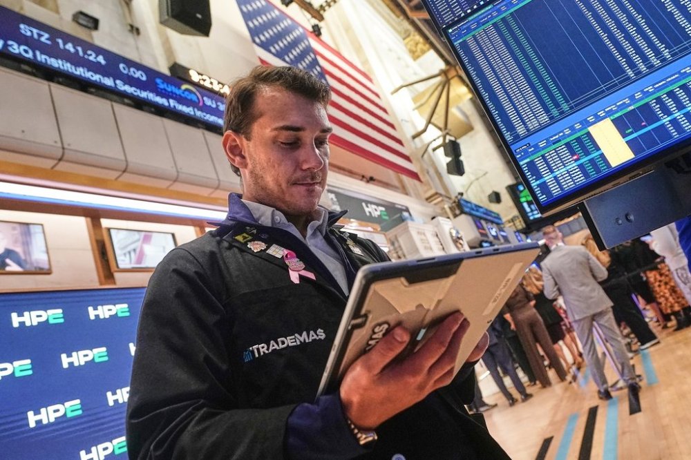 Trader Dylan Halvorsan works on the floor of the New York Stock Exchange, Wednesday, Oct. 15, 2025. (AP Photo/Richard Drew)