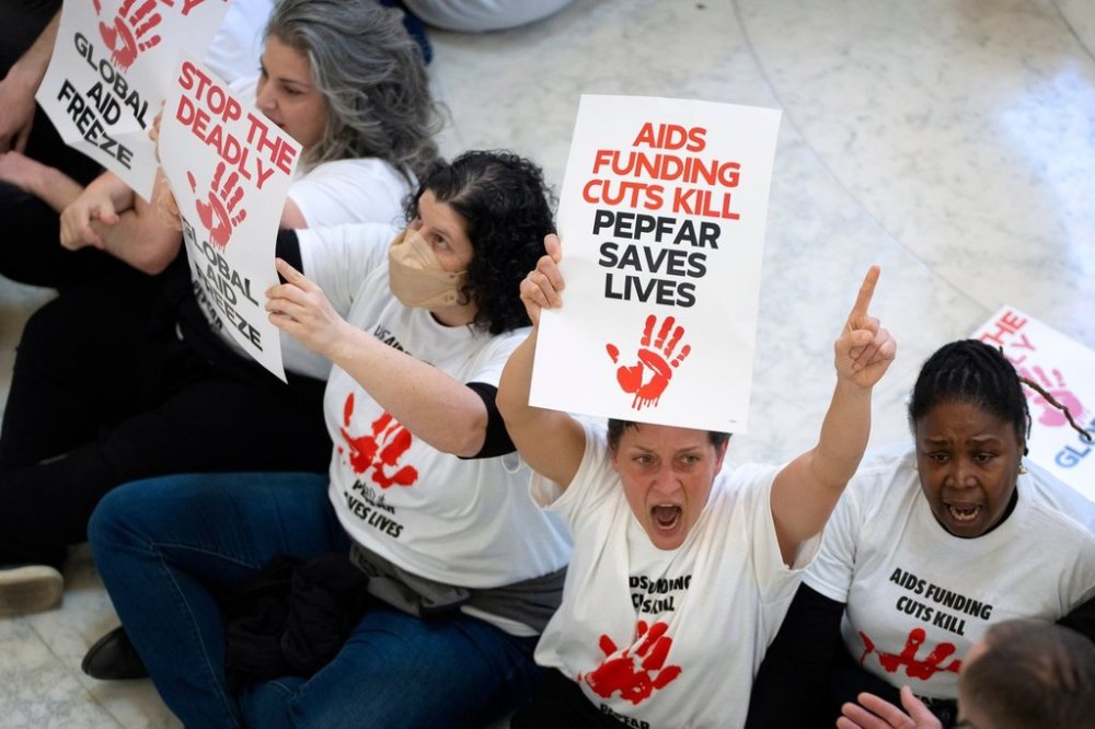 FILE - Demonstrators protest against cuts to American foreign aid spending, including USAID and the PEPFAR program to combat HIV/AIDS, at the Cannon House Office Building on Capitol Hill, Wednesday, Feb. 26, 2025, in Washington. (AP Photo/Mark Schiefelbein, File)