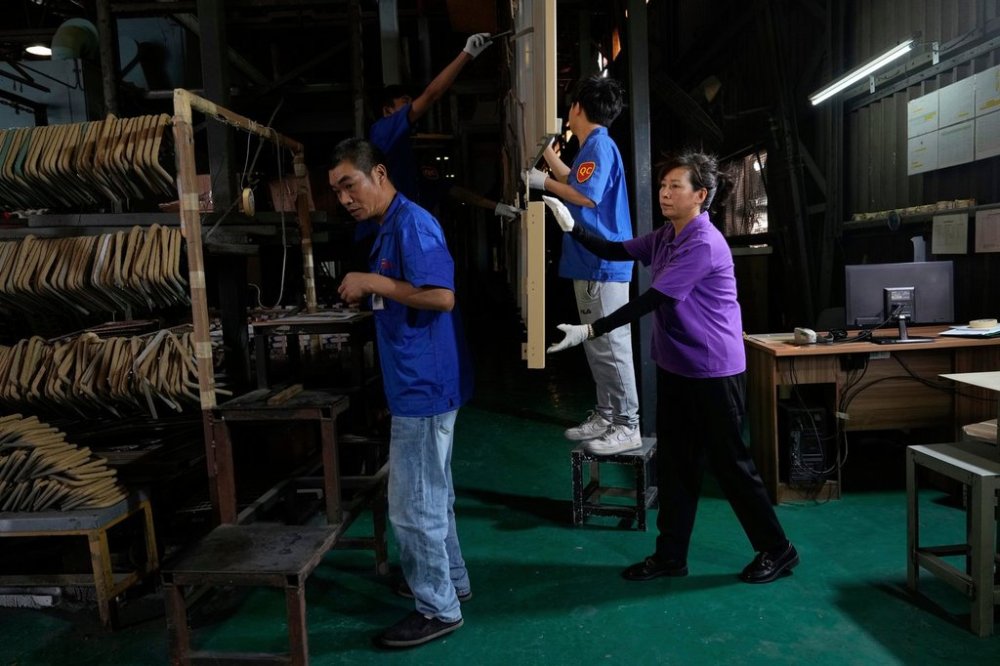 FILE - Workers check aluminum panels produced at a factory of Kam Pin Industrial (HK) Ltd, in Dongguan city in southern China's Guangdong province April 17, 2025. (AP Photo/Ng Han Guan, File)