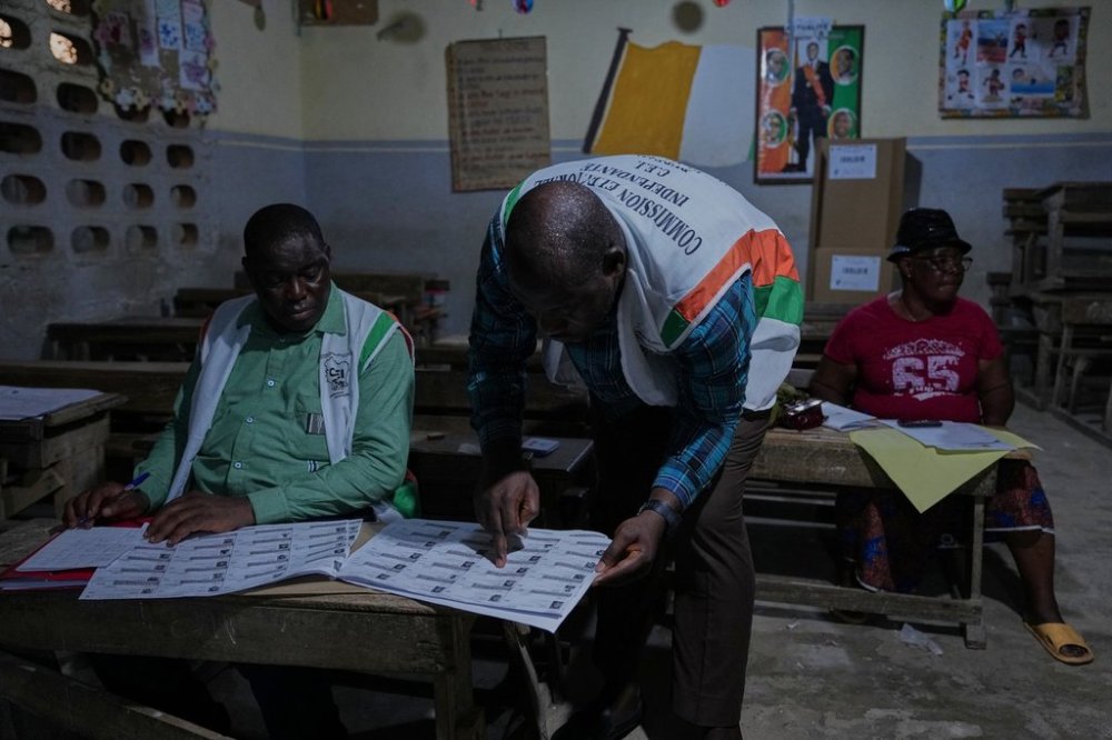 Officials count votes at a polling station in the Yopougon suburb of Abidjan, Ivory Coast, Saturday, Oct. 25, 2025, as polls close during the presidential elections. (AP Photo/Misper Apawu)