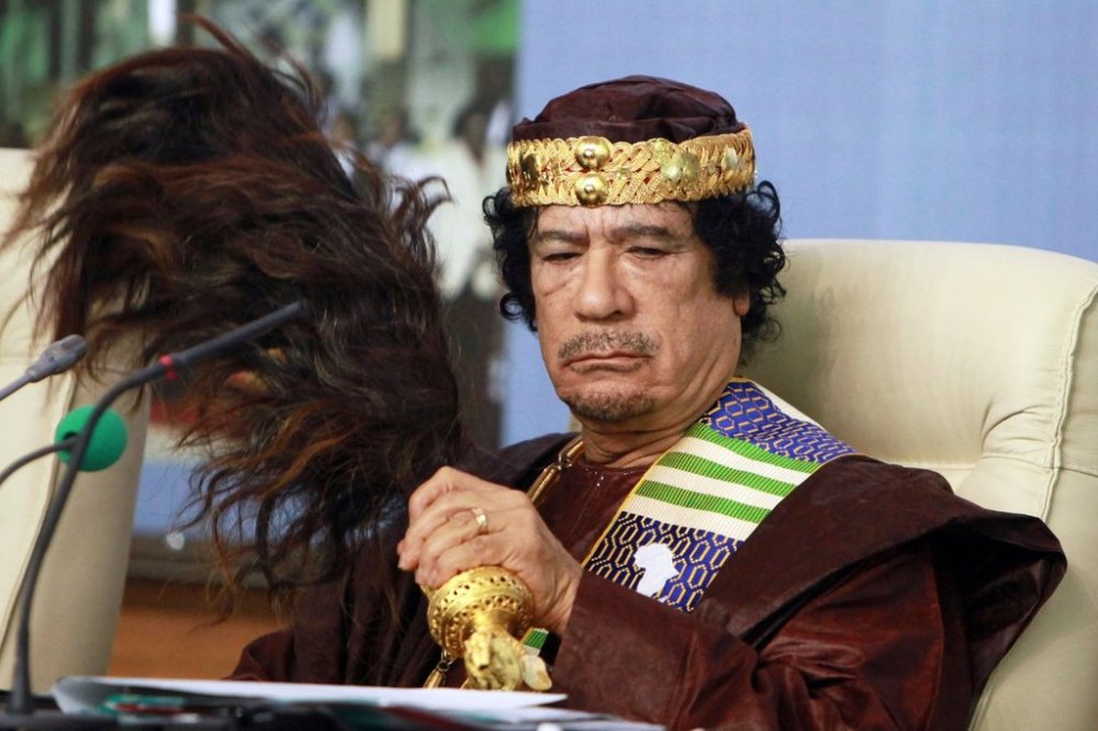 FILE - Libyan leader Moammar Gadhafi fans his face during the Forum of Kings, Princes, Sultans, Sheikhs and Mayors of Africa in Tripoli on Sept. 8 2010. (AP Photo/Abdel Magid Al Fergany, File)