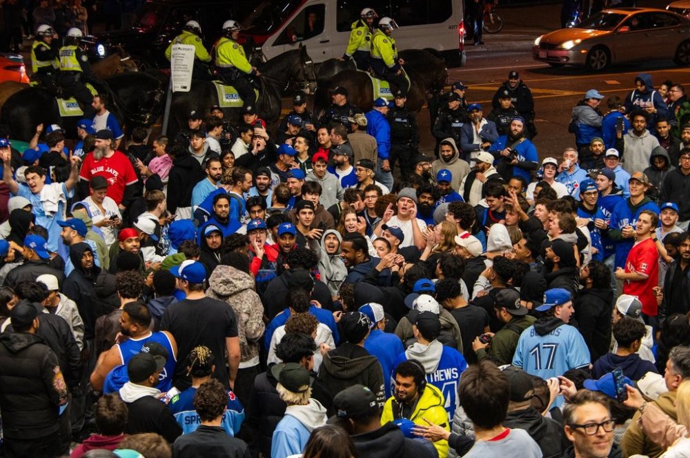 Toronto Blue Jays fans celebrate after the team beat the Seattle Mariners to win the American League Championship Series, in Toronto, Tuesday, Oct. 21, 2025. THE CANADIAN PRESS/Laura Proctor