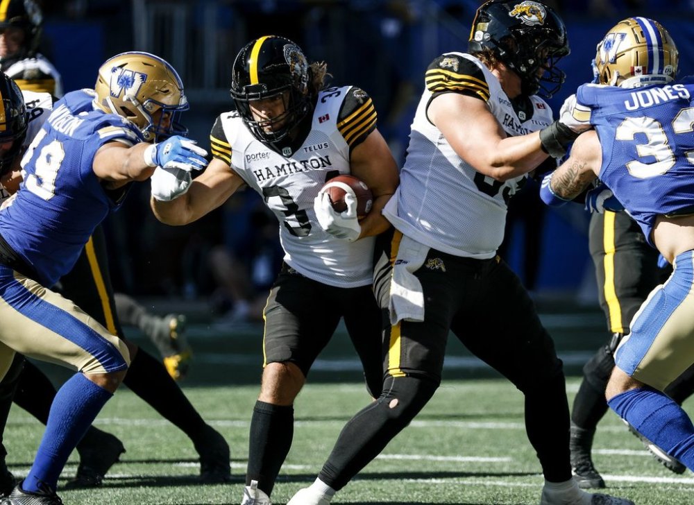 Hamilton Tiger-Cats quarterback Ante Milanovic-Litre (34) runs for the first down during first-half CFL action against the Winnipeg Blue Bombers in Winnipeg, Saturday, Sept. 27, 2025.    THE CANADIAN PRESS/John Woods