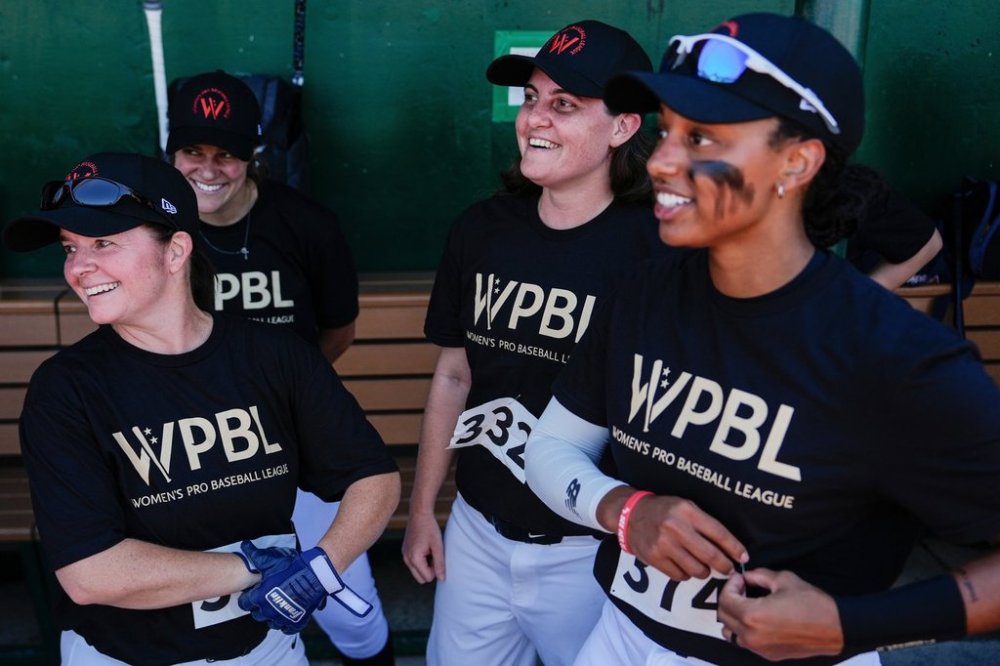 FILE - Lauren Boden, second from right, Stephanie Everett, right, and other players talk in the dugout during the first day of tryouts for the Women's Professional Baseball League, Friday, Aug 22, 2025, at the Washington Nationals Youth Baseball Academy in Washington. (AP Photo/Julia Demaree Nikhinson, file)
