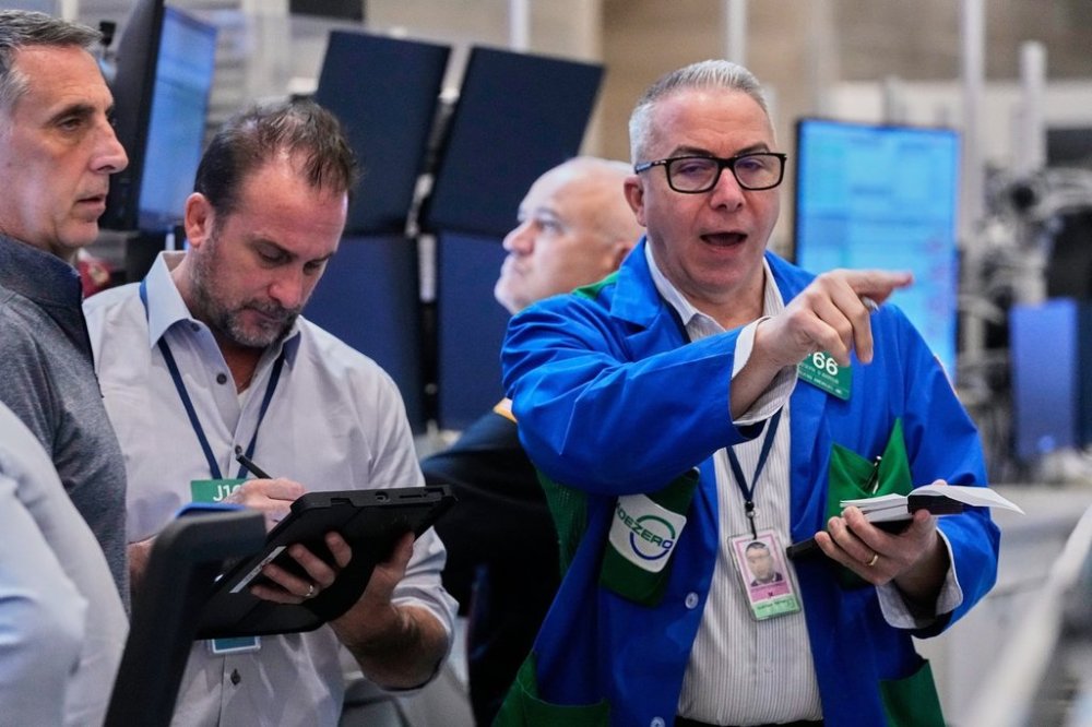 Options traders Joseph Arrigo, right, works on the floor of the New York Stock Exchange, Monday, Oct. 20, 2025. (AP Photo/Richard Drew)