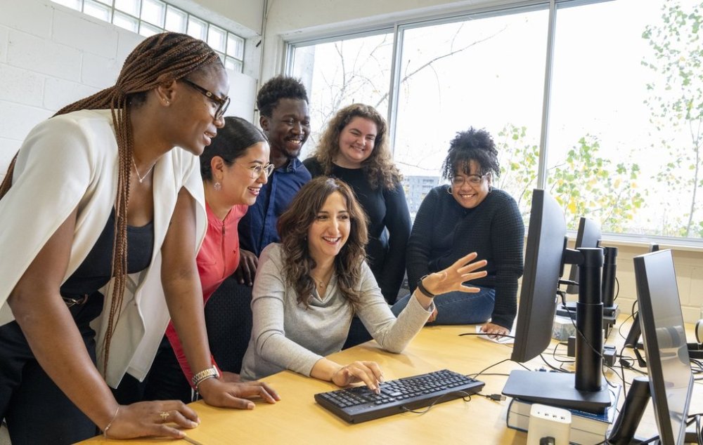 Fyscillia Ream, right, project manager of Reseau d'Assistance cyber-citoyen (RACC) from the IMC2 Institut, poses with her students from left to right, Josephine Sabze, Andrea Zeltzin Guadarrama Gaytan, Kamila Benamghar, Emmanuel Warren Songo-Kette, and Alice Carey after their cybersecurity debriefing at the offices of Institut du Nouveau Monde, a non-profit organization in Montreal on Thursday, Oct. 23, 2025. THE CANADIAN PRESS/Christinne Muschi