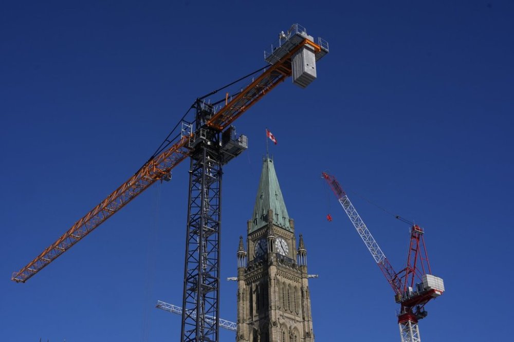 Cranes surround the Peace Tower in Ottawa on Parliament Hill as construction on centre block continues, Friday, Jan. 24, 2025. THE CANADIAN PRESS/Adrian Wyld