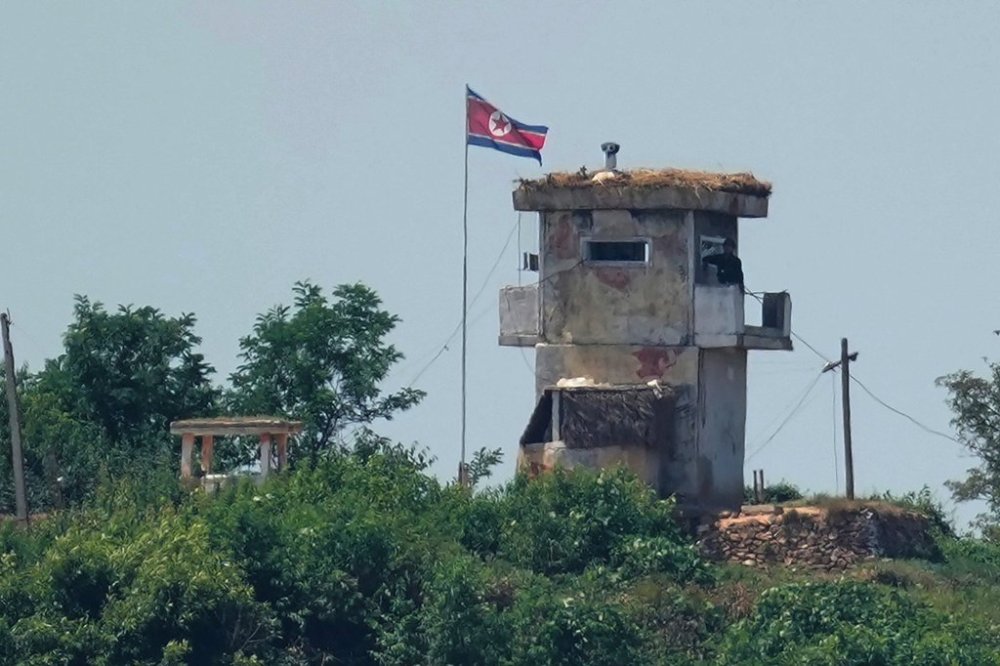 FILE - A soldier stands at a North Korean military guard post flying a national flag, seen from Paju, South Korea, June 26, 2024. (AP Photo/Lee Jin-man, File)