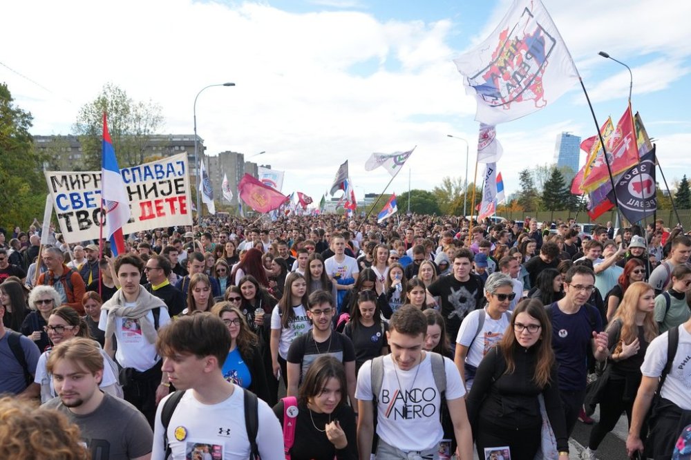 People gather, among them students, to walk on the street towards the northern city of Novi Sad, for a huge rally on Nov. 1 marking the first anniversary of a train station disaster that killed 16 people, in Belgrade, Serbia, Thursday, Oct. 30, 2025. (AP Photo/Darko Vojinovic)