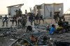 People gather among debris near a bridge in Black River, Jamaica, Thursday, Oct. 30, 2025, in the aftermath of Hurricane Melissa. (AP Photo/Matias Delacroix)