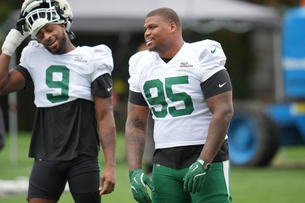 New York Jets defensive tackle Quinnen Williams, right, and defensive end Will McDonald IV react during NFL football practice at The Grove in Watford, England, Wednesday, Oct. 8, 2025. (AP Photo/Kin Cheung)