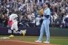 Toronto Blue Jays pitcher Shane Bieber (57) looks on as Seattle Mariners' Julio Rodríguez (44) rounds first base after hitting a two-run home run during first inning Game 3 American League Championship Series baseball action in Seattle on Wednesday, Oct. 15, 2025. THE CANADIAN PRESS/Frank Gunn