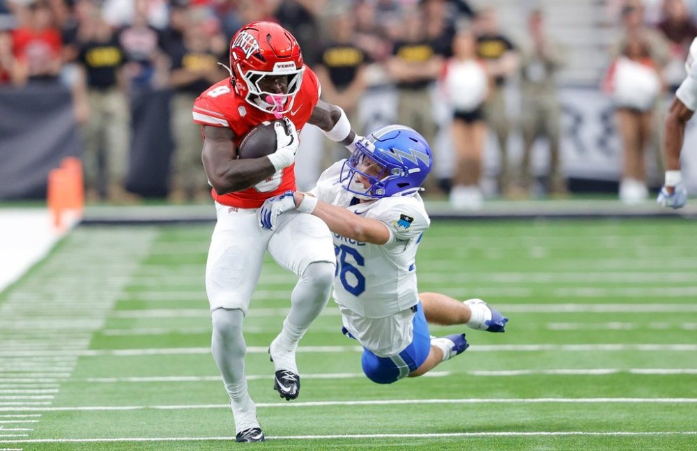 UNLV running back Jai'Den Thomas (9) is tackled by Air Force defensive back Max Mustell (36) during the first half of an NCAA football game Saturday, Oct. 11, 2025, in Las Vegas. (Steve Marcus/Las Vegas Sun via AP)