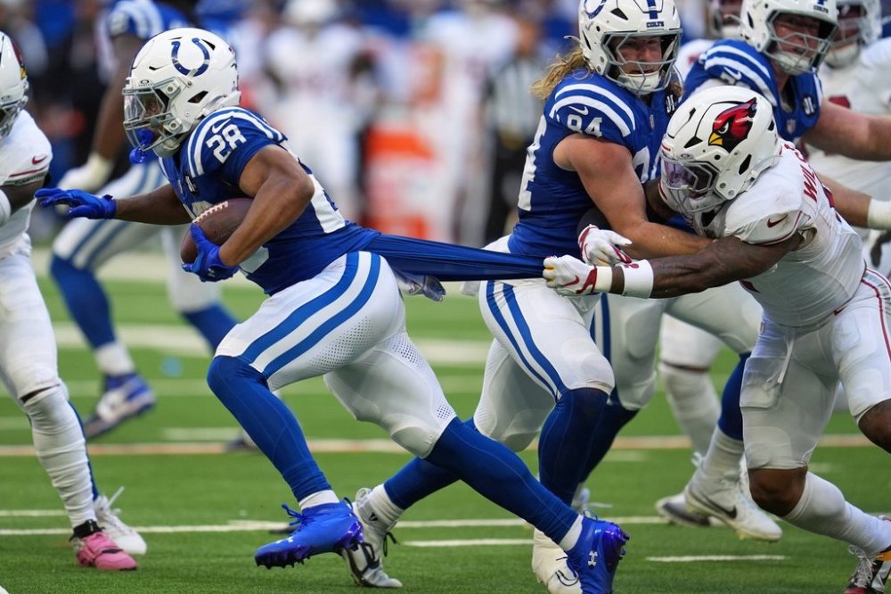 Arizona Cardinals' Mack Wilson stops Indianapolis Colts' Jonathan Taylor during the first half of an NFL football game Sunday, Oct. 12, 2025, in Indianapolis. (AP Photo/Michael Conroy)