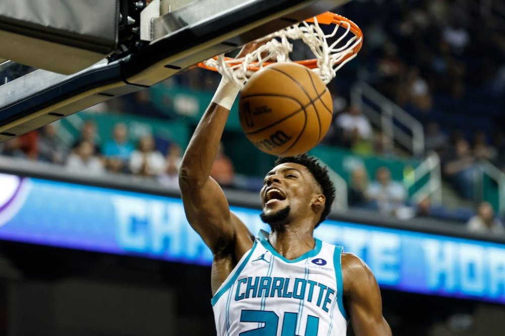 Charlotte Hornets forward Brandon Miller dunks during the second half of a preseason NBA basketball game during the second half in Greensboro, N.C., Wednesday, Oct. 15, 2025. (AP Photo/Nell Redmond)