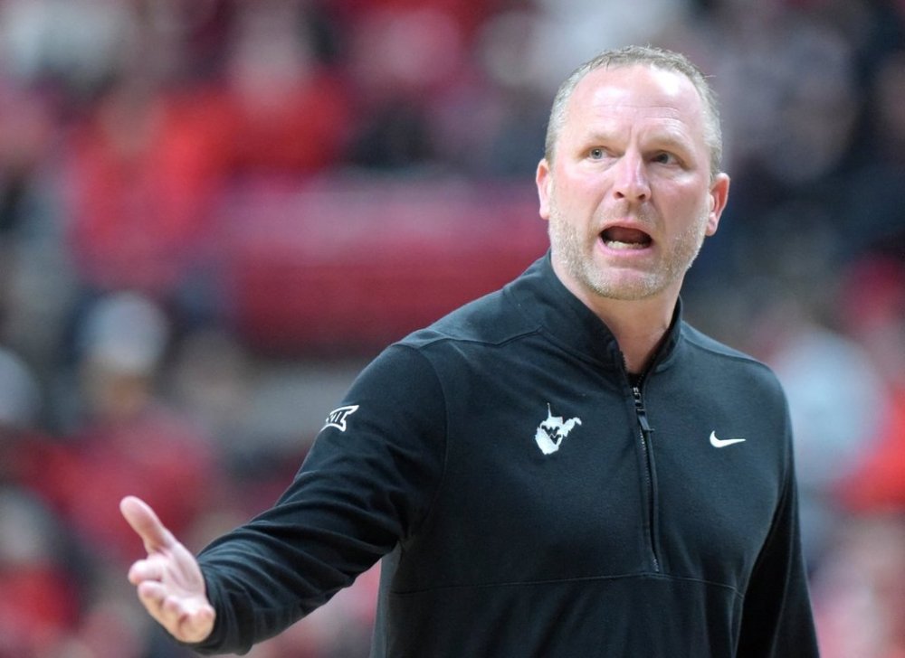 FILE - West Virginia head coach Darian DeVries, who is now head coach at Indiana, gestures to a referee during the first half of an NCAA college basketball game against Texas Tech, Feb. 22, 2025, in Lubbock, Texas. (AP Photo/Annie Rice, file)