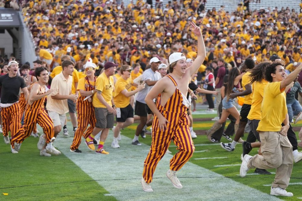 Arizona State fans rush the field after defeating Texas Tech during an NCAA college football game Saturday, Oct. 18, 2025, in Tempe, Ariz. (AP Photo/Rick Scuteri)