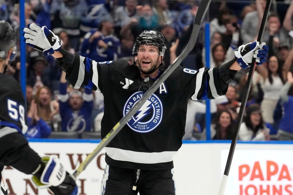 Tampa Bay Lightning right wing Nikita Kucherov (86) celebrates after picking up assist for his 1,000th career point on a goal by center Brayden Point during the second period of an NHL hockey game against the Anaheim Ducks Saturday, Oct. 25, 2025, in Tampa, Fla. (AP Photo/Chris O'Meara)