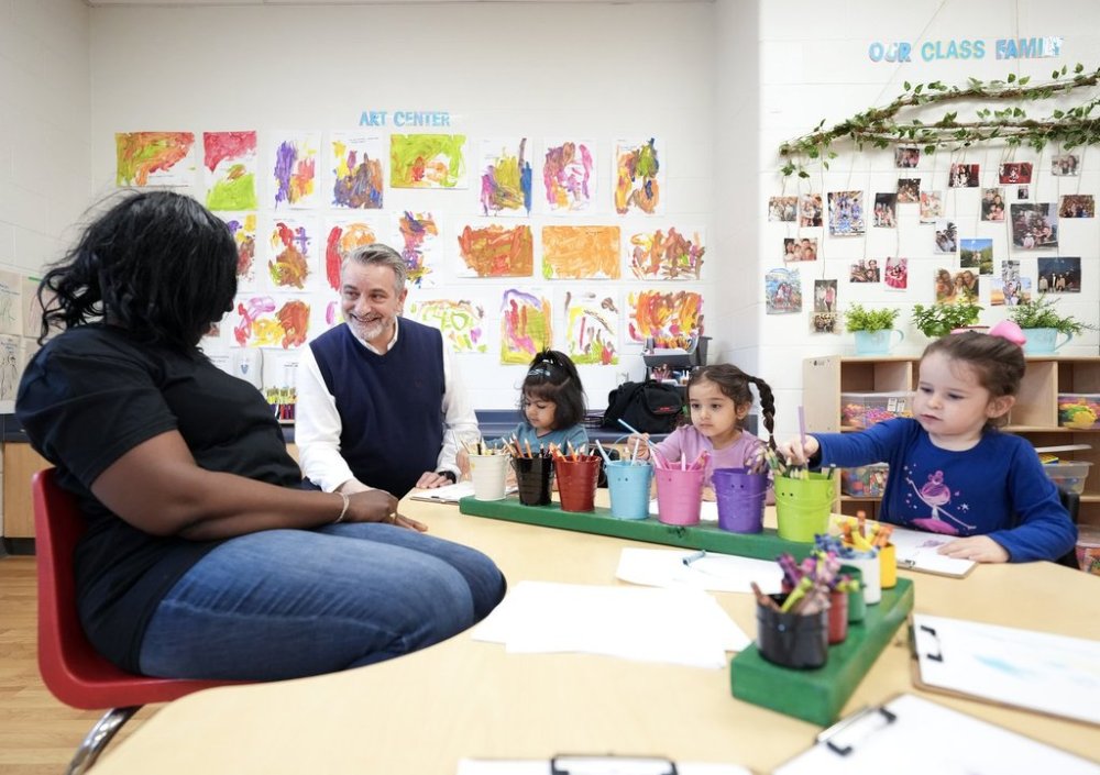 Ontario Minister of Education Paul Calandra, second right, visits children at the Blessed Chiara Badano Child Care Centre in Stouffville, Ont., Friday, May 2, 2025. THE CANADIAN PRESS/Nathan Denette
