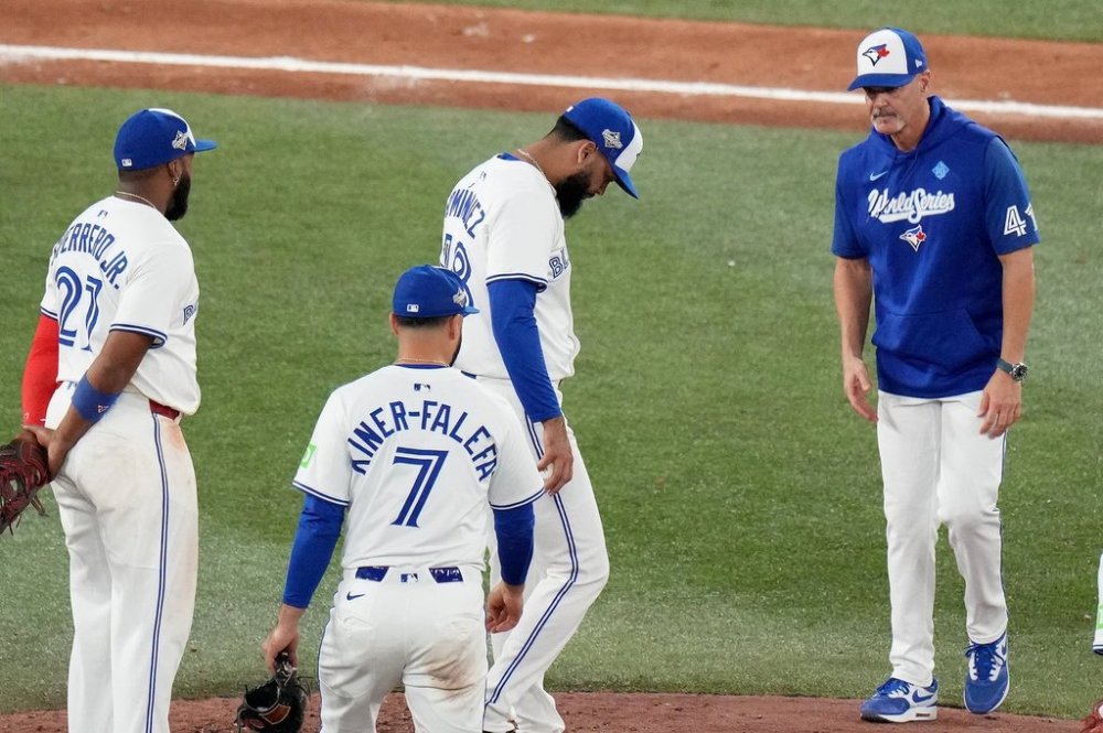 Toronto Blue Jays pitcher Seranthony Domínguez (48) gets a mound visit from pitching coach Pete Walker (41) after loading the bases during 10th inning Game 7 World Series playoff MLB baseball action against the Los Angeles Dodgers, in Toronto, Saturday, Nov. 1, 2025. THE CANADIAN PRESS/Chris Young