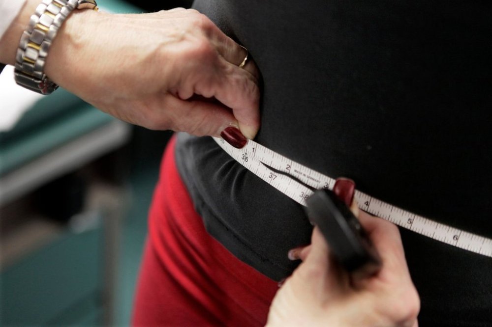 FILE - A subject's waist is measured during an obesity prevention study in Chicago on Jan. 20, 2010. (AP Photo/M. Spencer Green, File)